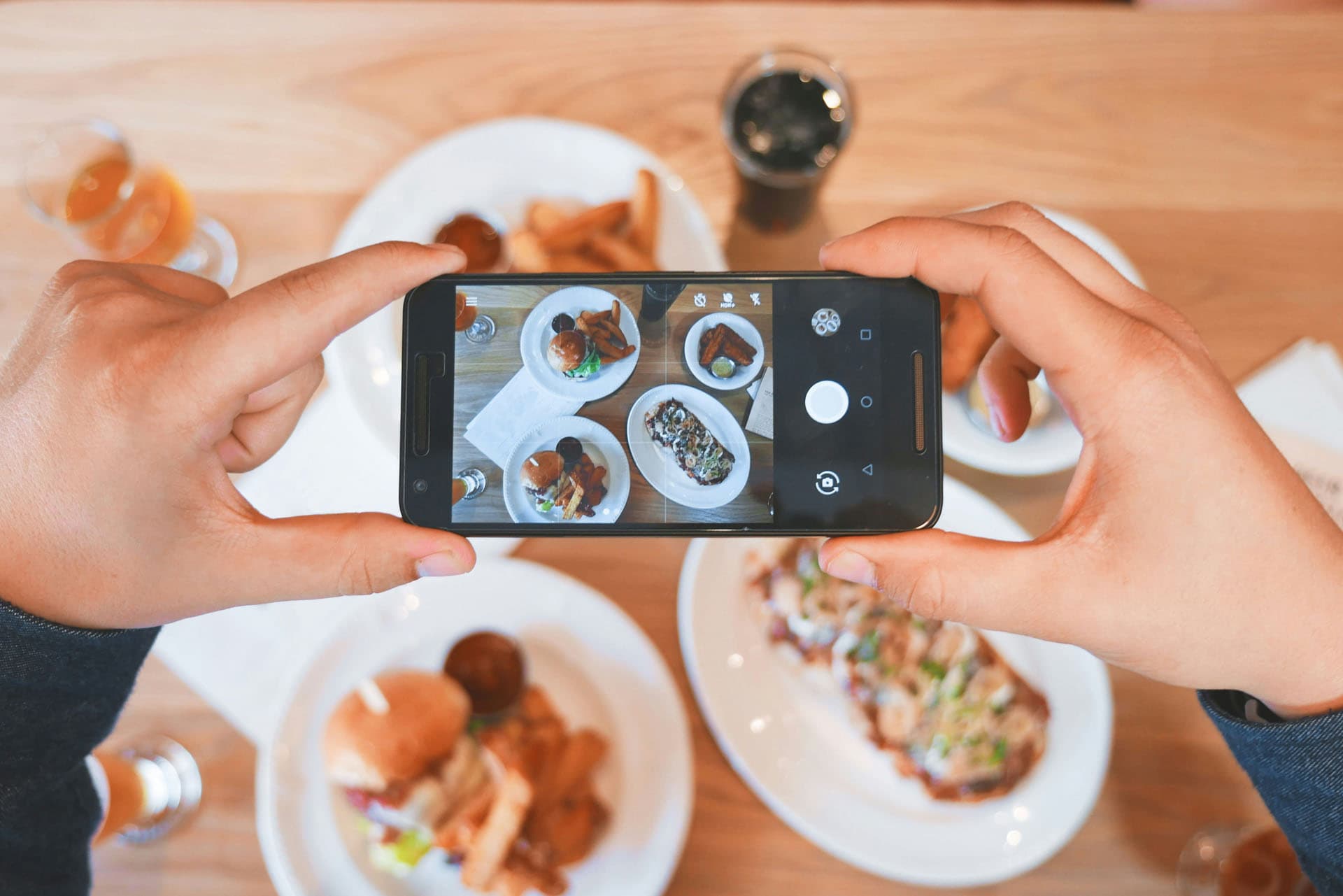 Photographing a dish with a phone for a restaurant's digital menu